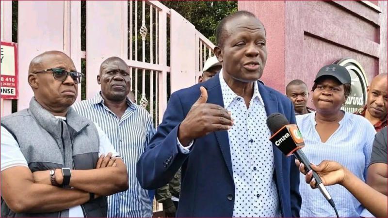 Former Foreign Affairs Minister Raphael Tuju address the press outside his property.